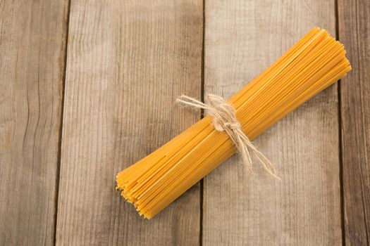 Bundle of raw spaghetti tied with rope