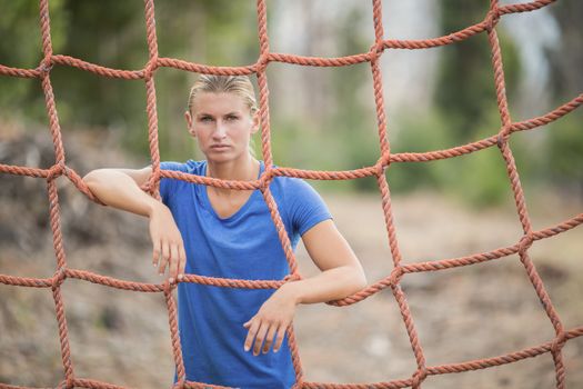 Fit woman standing near fitness trial at boot camp