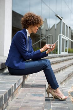 Businesswoman using mobile phone in the premises