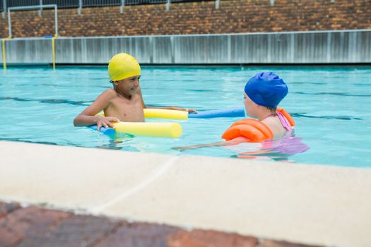 Two kids swimming in pool