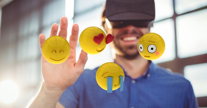Man looking at emojis through VR glasses