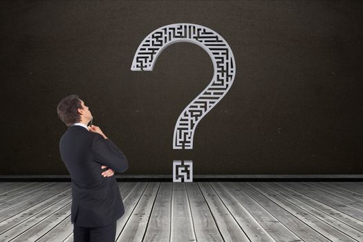 Businessman looking at question mark