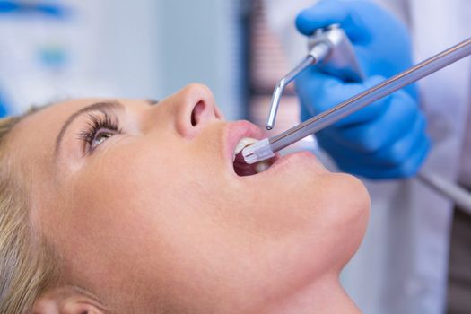 Extreme close up of dentist examining woman