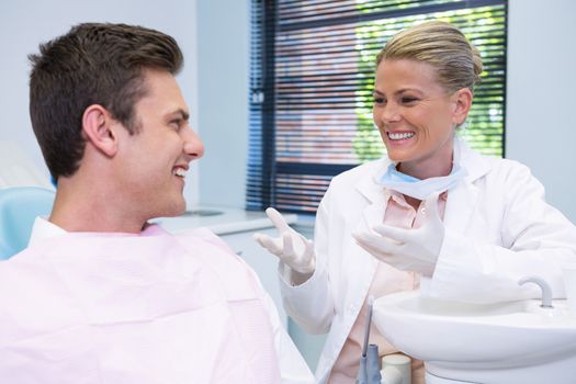 Happy patient discussing with dentist