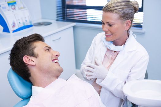 Man disscussing with dentist at medical clinic