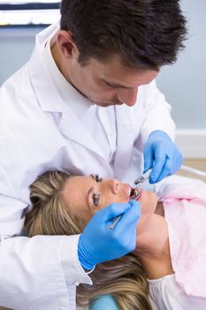 Dentist examining patient at medical clinic