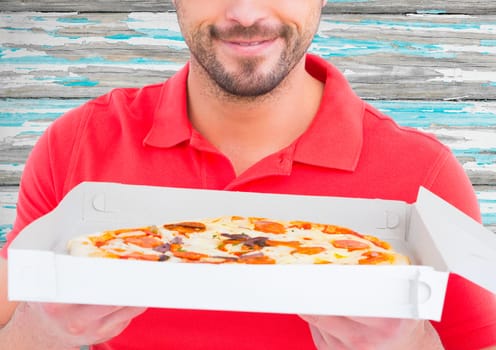 Deliveryman with pizza in foreground. Blue wood background