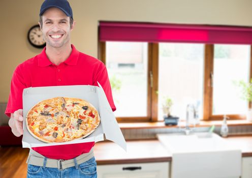 Happy delivery sowing the pizza in the kitchen