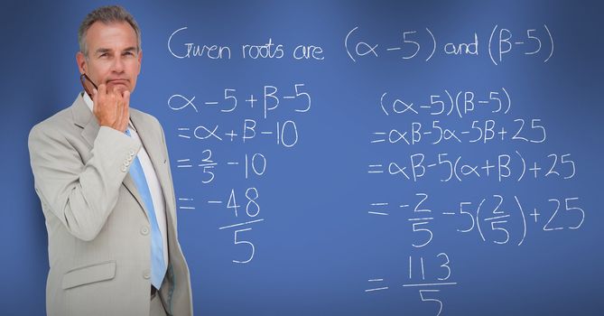 Thoughtful businessman standing by math equation