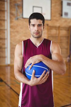 Determined basketball player holding a basketball