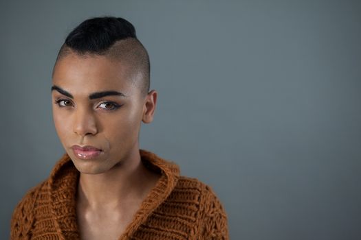 Transgender woman against gray background