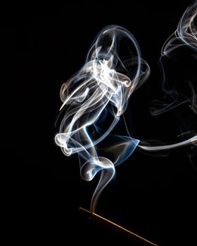 A trickle of smoke on a black background