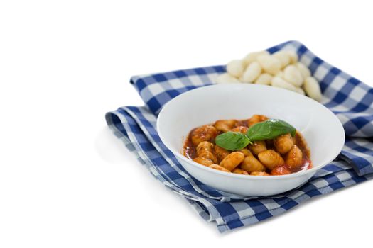 High angle view of gnocchi pasta in bowl on napkin