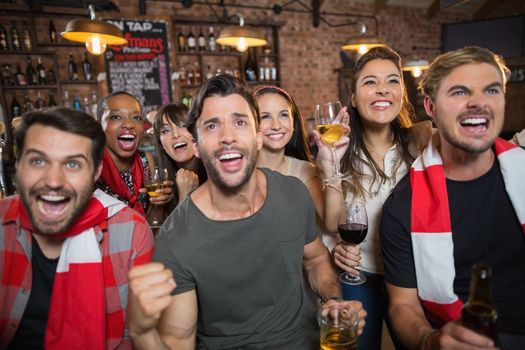 Cheerful friends enjoying in pub