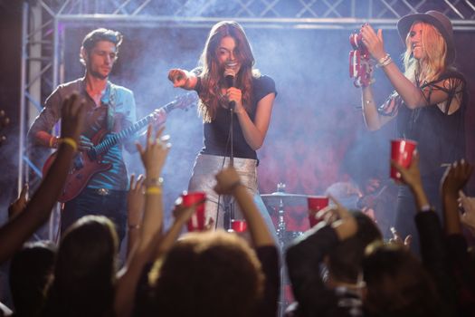 Female singer with musicians performing at nightclub