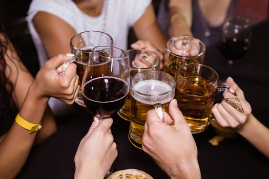 Friends toasting drinks at nightclub