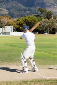 Batsman playing cricket on field