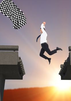 businessman jumping to catch the checker flag