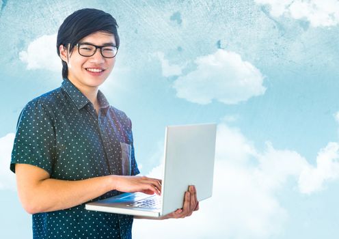 Trendy man with laptop against sky