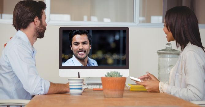 Business people video conferencing with colleague on computer