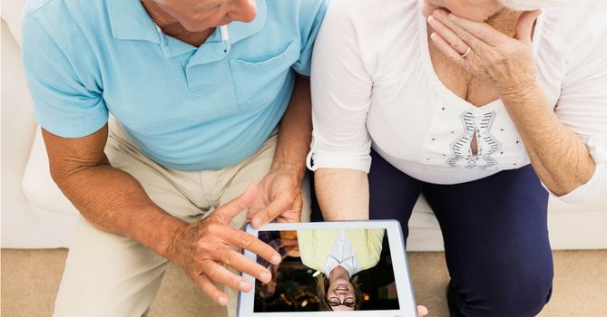 Senior couple video conferencing on tablet PC