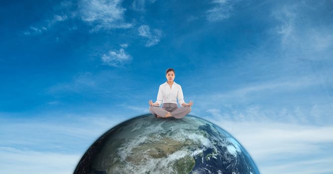 Businesswoman meditating on earth