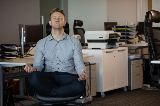 Executive meditating at desk