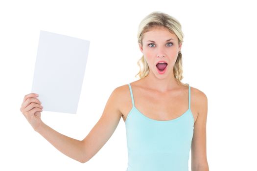 Shocked blonde holding a sheet of paper