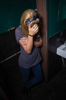 Unconscious woman standing in the washroom