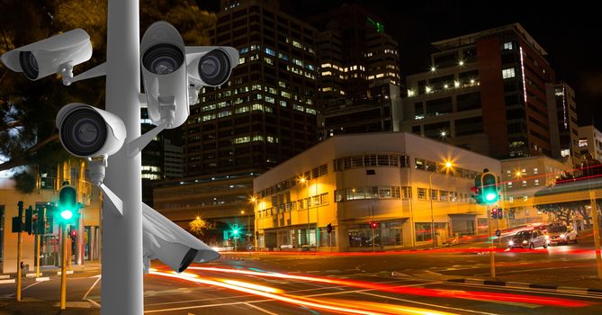 CCTV cameras against light trails in city at night