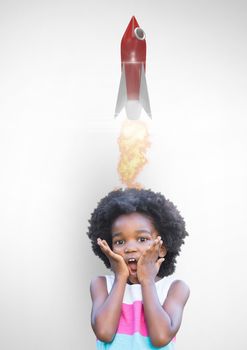 Digital composite image of kid with rocket launch on head