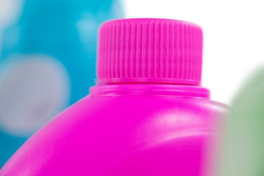 Pink detergent container on white background