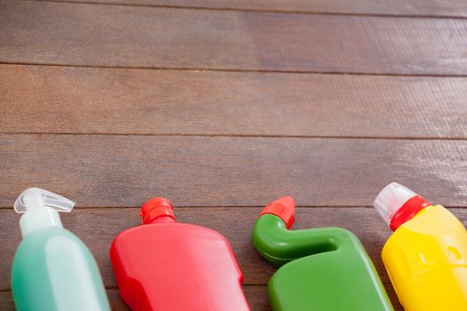 Detergent bottles arranged on a wooden floor