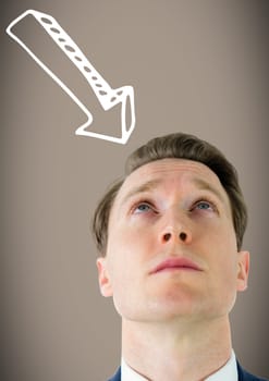 Man looking up at white downward arrow against brown background