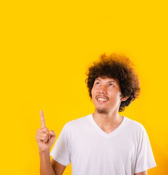 Asian Portrait happy young man curly hair pointing fingers away 