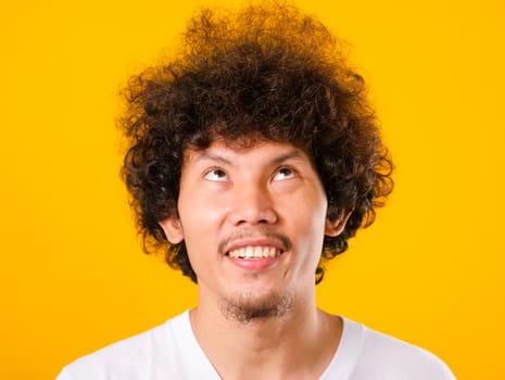 Asian handsome man with curly hair looking up see he hair isolat