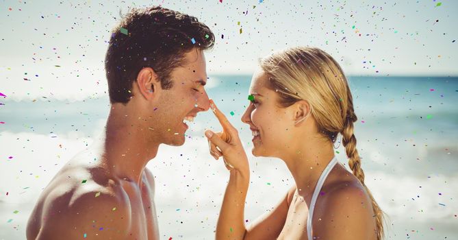 Confetti against couple on beach