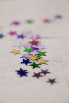 Colorful star shape decoration on white textile