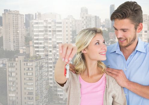 Couple  Holding key in front of high rise apartments