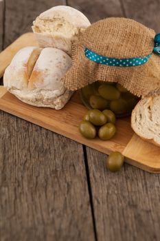 Olives in jar wrapped with jute by bread