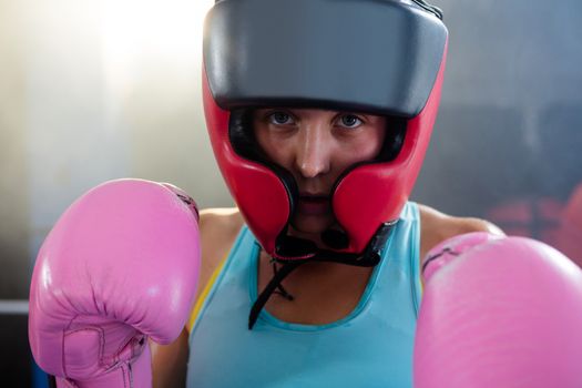 Close-up portrait of female boxer wearing protective headgear