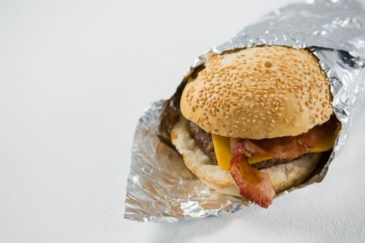 Close up of burger wrapped in foil paper