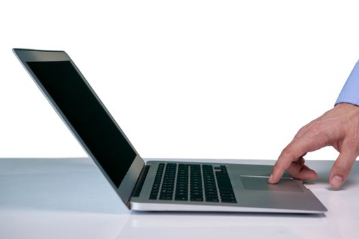 Cropped hand on businessman touching touch pad on laptop