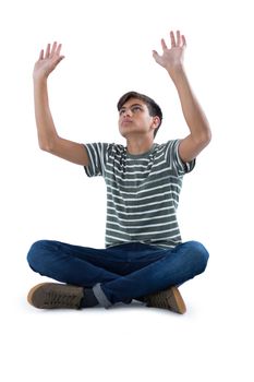 Teenage boy praying against white background