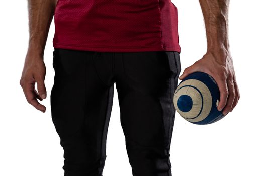 Midsection of sportsperson holding ball