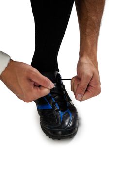 Cropped image of sports player tying shoelace