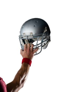 Cropped image of hand wearing wristband holding helmet