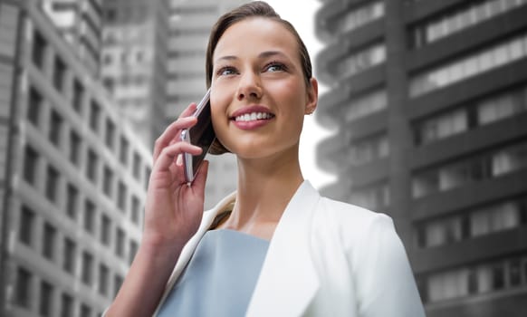Composite image of smiling businesswoman using smart phone