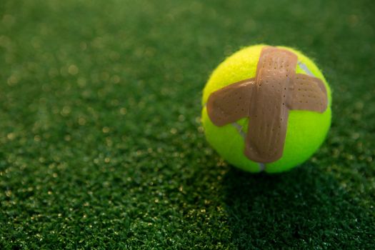 Close up of tennis ball with bandage