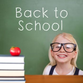 Cute pupil smiling against back to school message